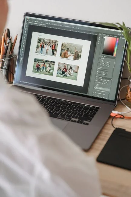 A sleek office desk setup featuring Apple devices: iMac, MacBook, and iPad.